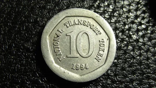 Купити 10 пенсів транспортний жетон 1994 Британія Терези