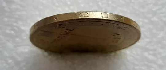 (4680) 1 гривня 2012 різновид викрошки у першій цифрі "2" слова "2012" на гурті (1 гривна 2012 брак) З аукціону