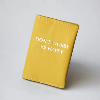 фото, Обкладинка для паспорта "Don't Worry Be Happy" жовта з посрібленням,біла нитка.