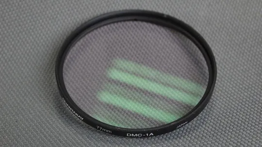 Quantaray DMC-1A 77мм. защитный ультрафиолетовый светофильтр 100% оригинал Japan Вживане Ціна